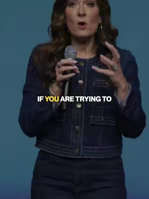 A woman with brown hair and a denim jacket is speaking into a microphone. Text overlayed on the image reads, "IF YOU ARE TRYING TO."