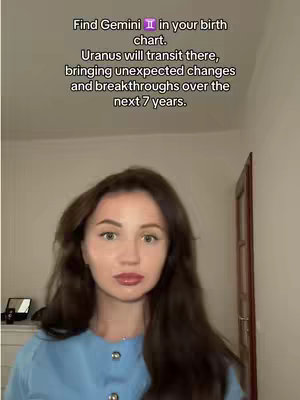 A young woman with long brown hair and a blue top stands in front of a light-colored wall. Text overlays the image, offering astrological insights. The scene is well-lit, suggesting an indoor setting.