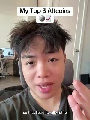 A selfie-style video cover image featuring a young Asian man in a dark-colored shirt. The background is a well-lit room. Above the man's head is a white text box that says "My Top 3 Altcoins". In the box, there is an image of a crescent moon and an upward-trending graph.
