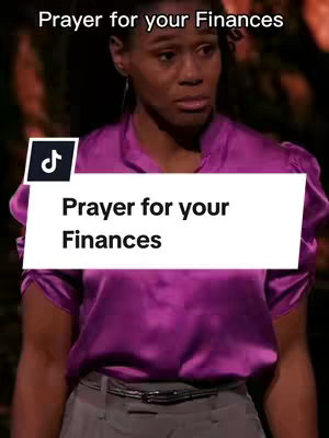 A woman with a serious expression is centered in the image. She is wearing a purple top and a light gray skirt. The background is dark, and the focus is on her upper body and face. A white rectangle with the text "Prayer for your Finances" is overlaid on the lower half of the image, and there is a small TikTok logo on the top left.