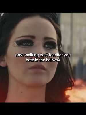 The image is a close-up shot of Jennifer Lawrence from a movie, featuring her face with intense eye makeup. Text overlayed reads, "pov: walking past teacher you hate in the hallway."