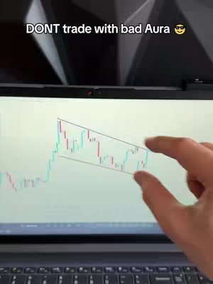 The cover image shows a laptop screen displaying a candlestick chart for trading, with a person's hand partially visible and pointing at the screen. Text overlay reads 'DONT trade with bad Aura.'