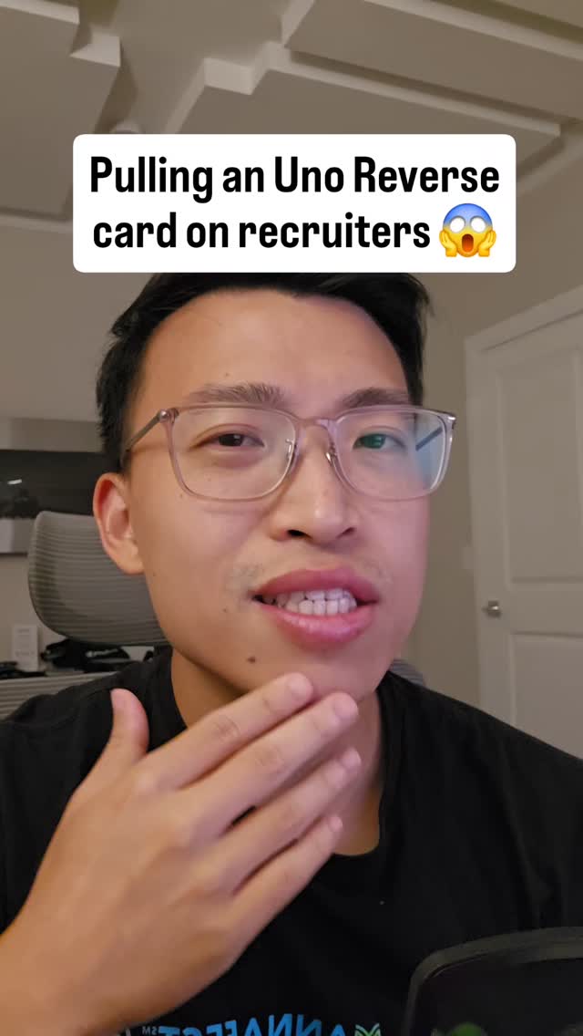 A young man with glasses is looking at the camera and touching his face. There is a text overlay that says, "Pulling an Uno Reverse card on recruiters 😮".