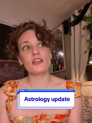 A woman with fair skin and curly brown hair looks sideways with a concerned expression. She wears a patterned orange top, and a text box overlay in front displays "Astrology update". The background features blurred room elements.
