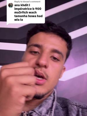 A selfie-style video showing a young man with dark hair and a slight beard. He is looking at the camera with an open mouth and his hand near his mouth.