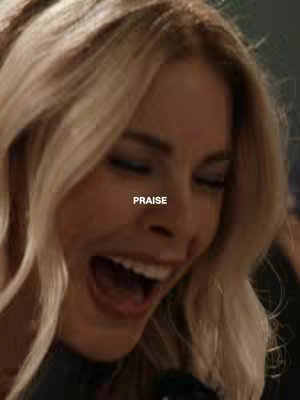 The image shows a close-up of a woman with blonde hair, singing with her mouth open. The word "PRAISE" is overlaid on the image.
