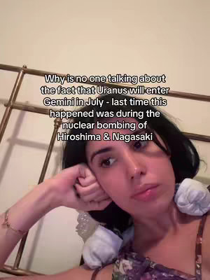 A woman with dark hair reclines against a bed frame, looking towards the camera. Text overlays the frame with astrological information.