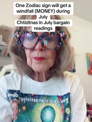 A close-up shot featuring a woman with short gray hair wearing embellished cat-eye glasses and a white t-shirt. The woman is the main focus, and the background is blurred. Text overlays appear at the top of the image.