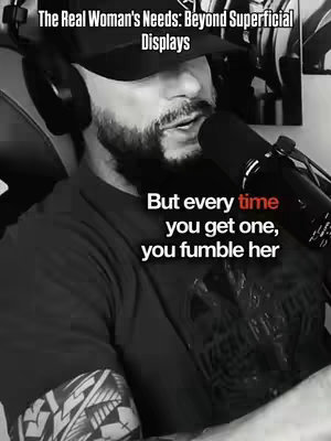A black and white image of a man with a beard in a baseball cap and headphones speaking into a microphone and with text overlayed.