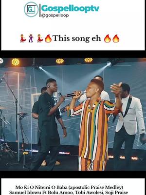 The cover image showcases a live performance by a gospel music group. The stage is lit with cool blue and white lights creating a dynamic atmosphere. A central figure, dressed in a vibrant patterned shirt, is singing into a microphone, with arms open as if praising. Other performers stand behind him, also holding microphones, adding to the live performance feel. The text overlay indicates this is a praise song.