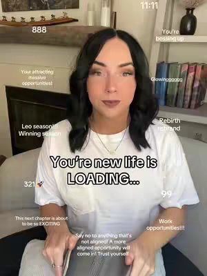A woman with dark hair is the central focus of the image, posed indoors. Various text overlays appear around her, with the main text overlay reading “You’re new life is LOADING…”. She appears to be holding a book or notebook, and the background includes shelves with decorative items and books.