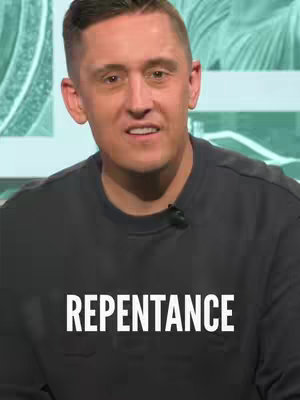 A man with short-cropped hair and a dark grey shirt is the central figure. The text 'REPENTANCE' is printed in large white bold letters across the lower portion of the shirt. The background is a soft, light green hue with a faint pattern suggestive of a leafy design, creating a shallow depth to the image. The man's expression appears to be focused, with an inquisitive look that suggests the video is informational.