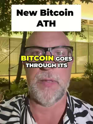 A man with a shaved head, glasses, and a beard is centered in the image. Text overlays are present, with a white rectangular box at the top reading 'New Bitcoin ATH'. A yellow text box near the eyes says 'BITCOIN GOES THROUGH ITS'. The background appears to be blurry, suggesting an outdoor setting.