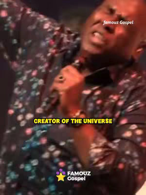 The image is a vertical shot of a Black man singing with intense emotion, likely on a stage. The background is blurred, suggesting a concert or performance setting. The man is wearing a shirt with a dark floral pattern. Text overlayed in a yellow box reads "CREATOR OF THE UNIVERSE."