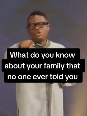The image shows a man in glasses, wearing a suit and a white shirt, speaking into the camera. Overlayed on the screen is a black bar containing white text.