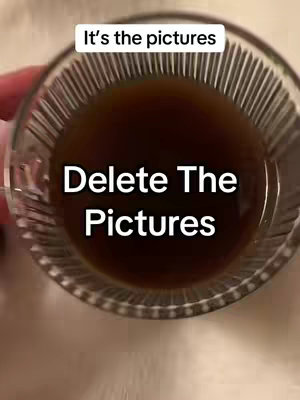 The cover image shows a clear glass cup filled with a dark liquid, likely coffee or tea, angled from a slightly elevated perspective. The liquid fills most of the frame, with some of the cup's rim visible at the top. The background and the surface beneath the cup are blurred, suggesting the focus is on the liquid within the cup. The composition is simple, with the cup centered and the dark liquid providing a strong visual element.