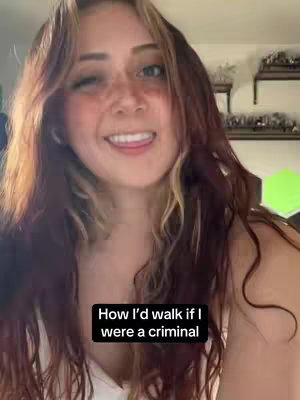 A young woman with long wavy hair smiles directly at the camera with one eye closed. A black box with white text is overlaid on the image.
