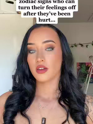 A woman with dark hair and makeup looks directly at the camera. Text is overlaid at the top.