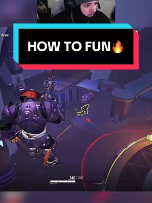 The cover image is a vertical video still capturing a gameplay scene with a streamer overlay. At the top of the frame, the streamer's face is partially visible, indicating a reaction or commentary during the game. Below the streamer's face, a title bar spans across the center with the text 'HOW TO FUN' in bold white letters, and a flame emoji, set against a teal and dark background with red accents, likely for improved visibility. The bottom half of the image displays a stylized game environment with a character model engaged in combat, and health bars. The overall tone suggests a gaming tutorial or a highlight reel meant to engage viewers.