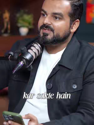 The cover image features a man speaking into a microphone. He's wearing a black jacket over a white t-shirt and holding a cellphone in his other hand. Text overlayed on the bottom of the image reads "kar sakte hain"