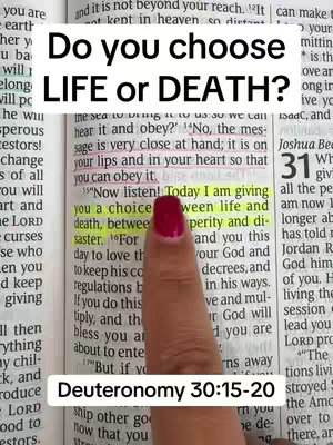 The image shows a close-up of an open book, with highlighting on the text for emphasis. A hand with a painted fingernail is pointing to a passage, with overlaying text that reads, "Do you choose LIFE or DEATH?". Below that there is also another text overlay that reads "Deuteronomy 30:15-20"
