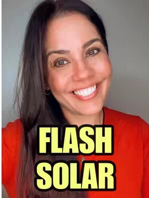A woman with dark hair is smiling widely, with text overlayed in a bold, yellow and black font. The background is a blurred light grey.