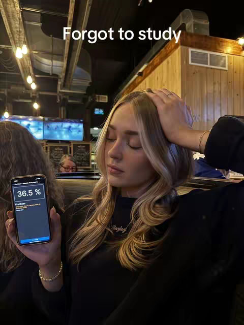 A young woman with long blonde hair is holding her head with one hand, her eyes are closed. She is also holding a phone in the other hand showing the screen that contains an app and its data. The background has a casual setting. The cover image conveys a sense of stress or contemplation.