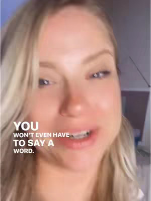 A close-up shot of a woman with long blonde hair, looking directly at the camera and speaking. Text overlays are positioned at the bottom of the image to display a message.