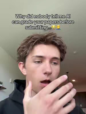 A young man with light brown hair is looking down and to the right with a surprised expression. Above him, text in a handwritten font discusses AI grading papers before submitting, with an emoji.