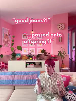 The cover image shows a woman sitting on a couch in a brightly lit, vividly pink room. She is wearing a patterned shirt and has short, red hair. The room includes art on the walls, houseplants, and a decorative clock. The woman is gesturing with both hands as if making a point, and text overlays '"good jeans?!"' and '"
...passed onto offspring?!"' are placed on top.