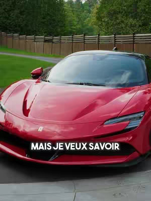 The cover image showcases a gleaming red Ferrari SF90 positioned outdoors. The car is centered, with the camera slightly angled towards its front. The car’s sleek design and glossy finish are emphasized. In the foreground, the text "MAIS JE VEUX SAVOIR" is prominently displayed in a white font. Behind the car, a green lawn, trees, and a wooden fence suggest a residential setting.