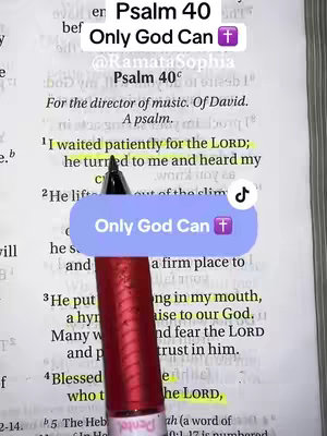 An open Bible lies on a surface. The focus is on a passage from Psalm 40, with text highlighted in yellow. A pen lies across the page, and a sticker with "Only God Can" text and a cross icon covers a portion of the text. The composition is a close-up shot that highlights the scripture. The background of the image shows more of the book.