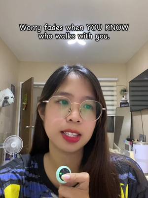A woman with long dark hair and glasses is holding a device that has a lit led button in front of her. The text overlay on top says "Worry fades when YOU KNOW who walks with you".