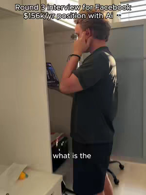 A man in a black shirt, likely in a closet or pantry, consults a tablet held near his face. Text overlays describe an interview setting.