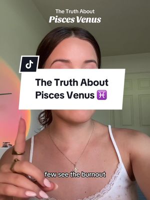 A woman is the central focus, framed from the chest up, against the interior setting. She gazes directly at the camera. A large white rectangle with black text overlay sits over her midsection. A small black TikTok logo rests in the top left corner. She wears a white top and a necklace with a pendant; a gold ring is around her finger. Her finger is pointed towards herself, as if making a point. Soft colors and warm lighting create a natural, inviting ambience.