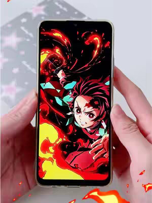 The image shows a smartphone held by two hands, displaying a dynamic wallpaper of an anime character with fiery effects. The character, featuring distinctive red and black hair and intense eyes, is positioned amidst dynamic flames and red energy, set against a black backdrop. The overall composition is vibrant and full of motion, with a focus on the visual impact of the artwork.