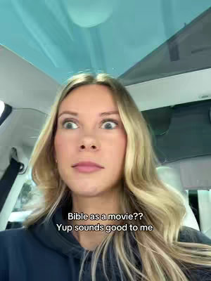 The cover image shows a young woman looking upward with wide eyes and a surprised expression while sitting inside a vehicle with a clear roof. The text overlay prompts a question about the Bible as a movie. The background is a car interior.