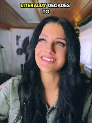 A woman with long, dark hair smiles widely while looking upward. She wears a light-colored top. Text in a yellow box reads 'Literally Decades To' at the top of the frame.
