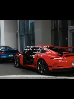 The cover image shows two cars in a parking area with a building in the background and text overlayed on it. The car in the front is an open red sports car parked and a blue sports car is parked behind at an angle.