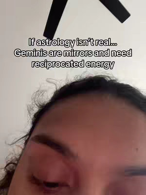 The cover image is a selfie-style shot, showcasing the upper part of a person's face. The person has dark hair and is looking down and slightly to the side. The top of a black ceiling fan is visible in the background. Overlaying the image at the top is a text overlay that reads 'If astrology isn’t real… Geminis are mirrors and need reciprocated energy.' The composition is simple, with the focus primarily on the person's face and the text overlaid.