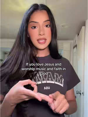 A woman with long dark hair is in a room, looking towards the viewer and talking. The woman is wearing a black shirt with the text "MIA" on it. Overlayed on the image is text that details the subject of the video.