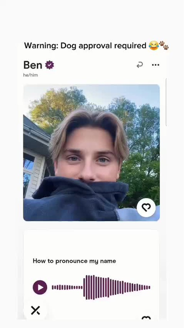 The cover image features a young man with light hair pulled back slightly, the top of his head and his eyes are visible over, and he is wearing a black hoodie, obscuring the majority of his face. The background features a green outdoor setting with trees. Two user interface elements, a like button and a 'how to pronounce my name' element, sit below the main image.