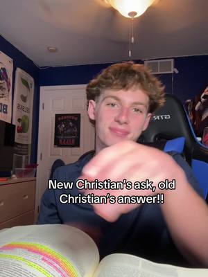 A young man sits in a room with blue walls, a poster, and a gaming chair, looking at the camera and smiling. The video includes the text overlayed on the image.