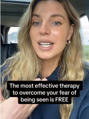 A woman with blonde hair and silver hoop earrings is centered in a car, looking straight ahead and speaking. Below her, a black overlay states the video's message.