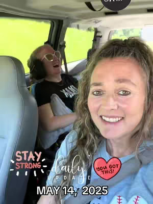 A selfie taken inside a vehicle, with the creator in the foreground smiling. In the background, another person is laughing. Text overlays include a daily update and the date, May 14, 2025, along with other graphics.