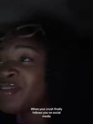 A selfie-style shot taken in a dimly lit setting. The frame focuses on a person's face, specifically the area above the mouth. Text overlayed at the image's base details the scenario with a caption reading: 'When your crush finally follows you on social media.'