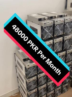 The image shows multiple cryptocurrency mining machines stacked vertically, arranged in rows. A diagonal text overlay dominates the image, with a black background and white text reading "48000 PKR Per Month", the text is framed by a red and blue border. The machines are metallic-gray in color with visible fans. The background is plain.