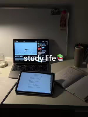The cover image shows a dimly lit desk with a laptop displaying a video, a tablet with text, and some books. A can of soda and other items are on the desk, with a white board in the background.