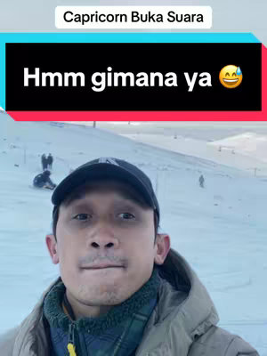A man in a black hat and jacket selfies in front of a snowy mountain background with text overlay