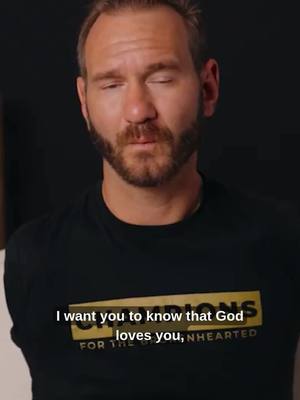 A medium shot features a man with short hair, a beard, and closed eyes, set against a softly lit, neutral background. He's wearing a black t-shirt with yellow text at the bottom, and a text overlay with white and yellow fonts. The overall composition is simple and focused on the man's expression, suggesting a moment of introspection.